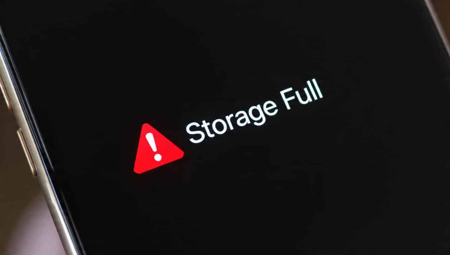 A smartphone screen displays a warning message with a red triangle and exclamation mark, reading "Storage Full," alerting users that System Data or Other storage may be taking up significant space.